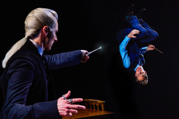 Draco Malfoy (Lachlan Woods) turns Harry Potter (Gareth Reeves) upside down during a wizarding duel in the Princess Theatre production of Harry Potter and the Cursed Child.