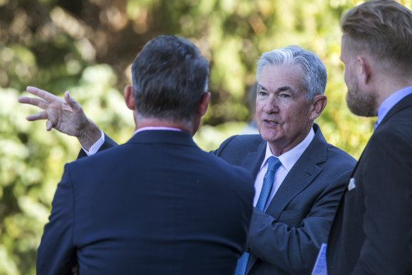 Federal Reserve Chair Jerome Powell, center, takes a coffee break with attendees of the central bank’s annual symposium at Jackson Hole.