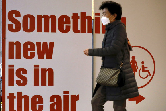 A tourist wears a protective mask while waiting for a flight to South Korea at the Ben Gurion airport near Tel Aviv in Israel.