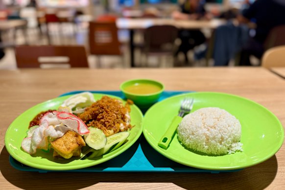 Tucking into Ayam penyet from Bidadari Muslim Cuisine at Changi’s Airport’s Terminal 1 staff canteen.