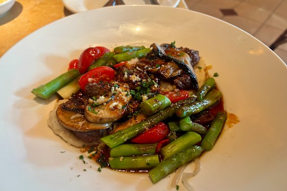 Beef medallions with mushrooms, cherry tomatoes, asparagus and mashed potato at The Cheesecake Factory.