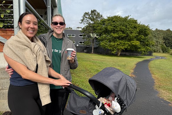 Iesha Moulden with daughter Mya and friend Melissa Martens on the path outside Q Roasters that was once a dirt track.