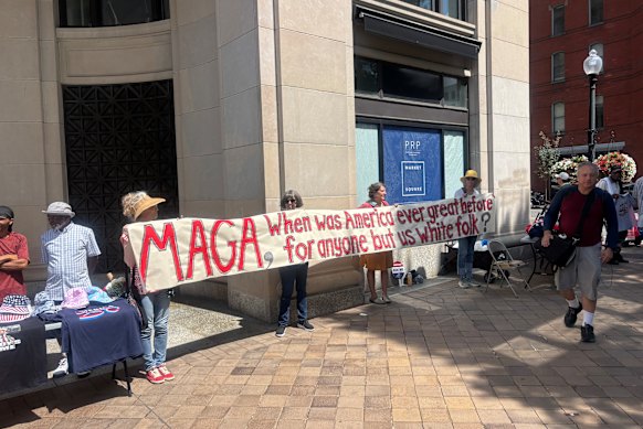Erika Berg, holding the banner on the left, said she and her fellow white women were protesting white supremacy.