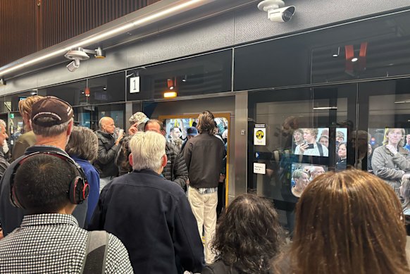 Commuters wait to get on the packed  train at Town Hall station.