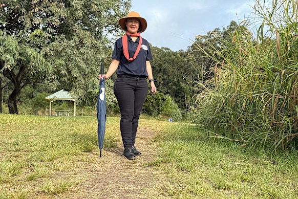 Anna Campbell on a desire path leading to a bridge over Kedron Brook.
