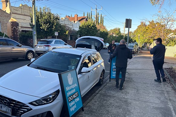 Boroondara council officers confiscating signs in Kew.