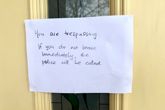 A sign threatening to call the police outside of the home of Erin Patterson’s sister.