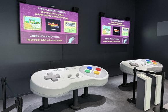 One of the interactive exhibits has pairs of players sharing a giant controller.
