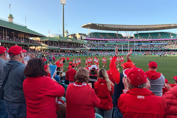 Swans players are cheered as they walk off at half-time.