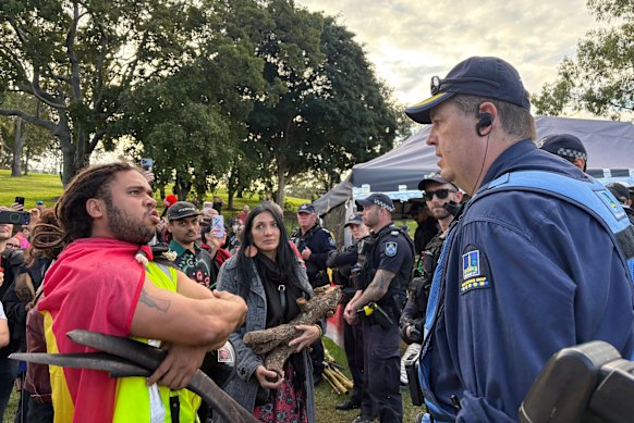 Councillor Seal Chong Wah (centre) and protesters confront police.