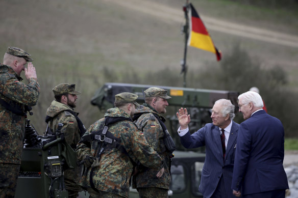 King Charles III, second from right, and German President Frank-Walter Steinmeier talk to soldiers from the 130th German-British Pioneer Bridge Battalion military unit in Finowfurt, eastern Germany on Thursday.