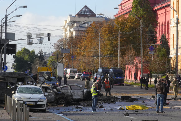 Police inspect the scene of Russian shelling in Kyiv on Monday.