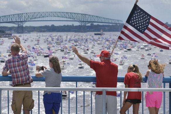 Trump supporters wave at hundreds of boats on the St Johns River in Florida to celebrate Trump's 74th birthday.