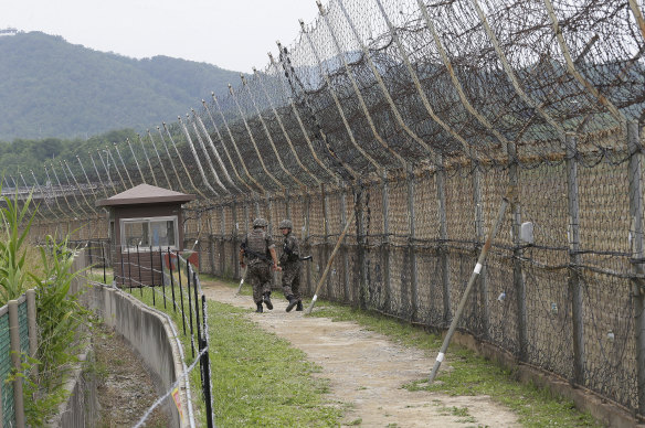 South Korean army soldiers patrol along the demilitarised zone in Goseong, South Korea. The DMZ is 250km long and about 4km wide, dividing the Korean Peninsula into North and South.
