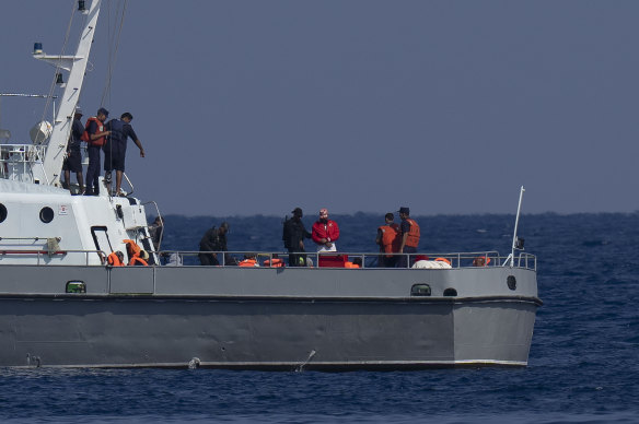 The would-be migrants are transferred to the Cuban coast guard boat off Havana.