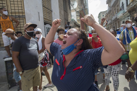 A woman shouts pro-government slogans as anti-government protesters march in Havana.