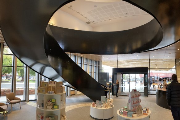 The curvaceous black steel staircase draws the gaze towards the skylight.