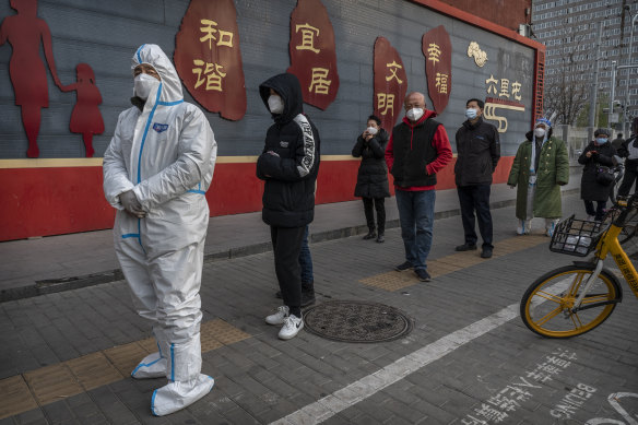 People in Beijing queue for a nucleic acid test. Attempts to ease strict zero-COVID rules have coincided with the worst outbreak in six months.