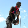 A Demons scarf adorns the statue of Jim Stynes outside the MCG.
