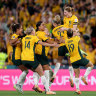 Matildas players and supporters celebrate Cortnee Vine’s winning penalty against France.