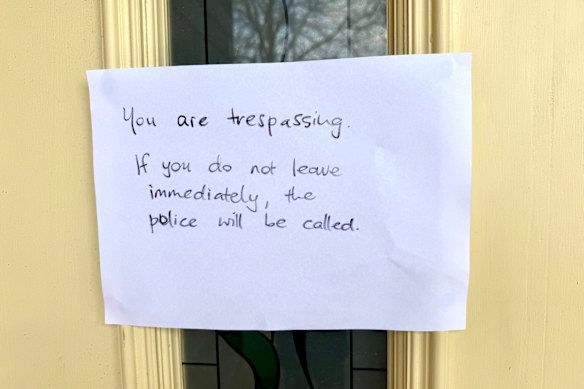 A sign threatening to call the police outside of home of Erin Patterson’s sister.