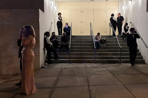 Guests and hotel workers outside the Washington Hilton after they were forced to evacuate.
