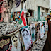 A cleric takes a photograph at the shattered Shajareh Tayyebeh school, which has become a place of mourning and a memorial to those killed in a U.S. airstrike on Feb. 28, in Minab, southern Iran, Monday, Sept. 7, 2026. (AP Photo/Vahid Salemi)