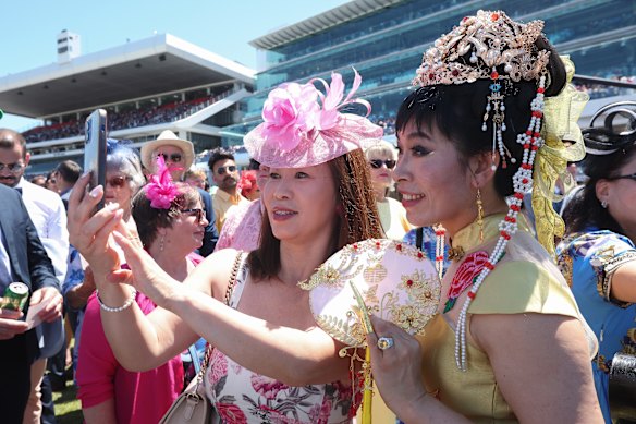 Race goers pose during Melbourne Cup Day.