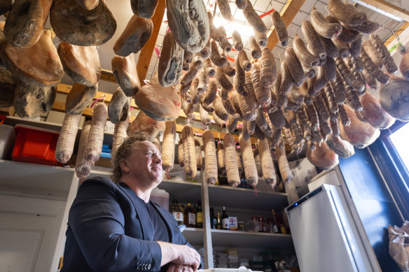 La Luna owner Adrian Richardson surrounded by house-made smallgoods.