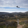 Doppelmayr Australia engineers install one of the new towers at Perisher by helicopter on Friday.