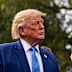 President Donald Trump listens as Elon Musk speaks outside the West Wing of the White House.