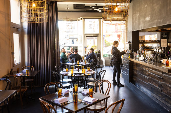 Dark walls and light fixtures made from fencing wire create a masculine aesthetic at La Luna.