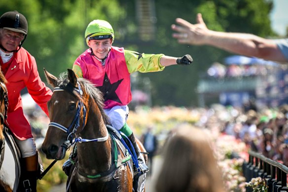 Winning jockey Robbie Dolan celebrates as he returns to scale after winning the Melbourne Cup on Knight’s Choice.