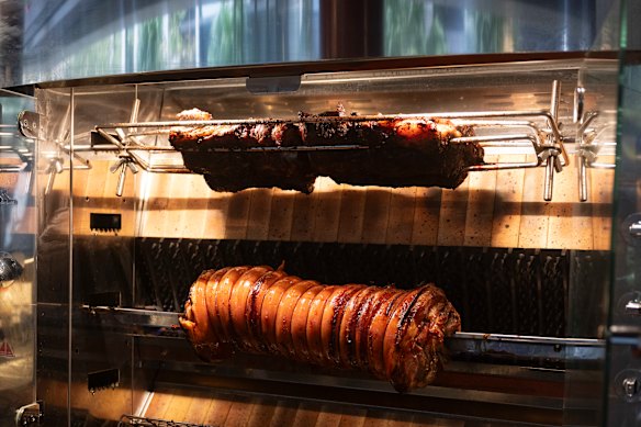 The rotisserie where the meats are cooked.