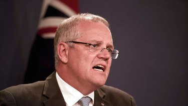 Prime Minister Scott Morrison will review the government's decision to slash Foodbank funding.