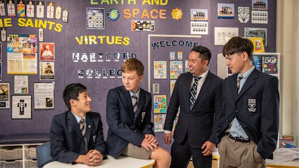 Hartford College principal Ian Mejia with students Matthew, Ben and Will. The all-boys school requires its students to read books from the literary canon.  