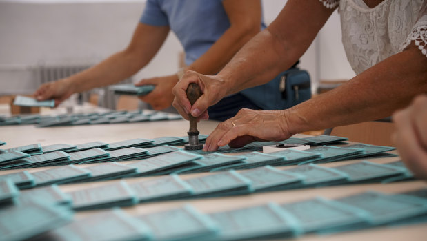 Volunteers stamp ballots at a polling station in Rome.