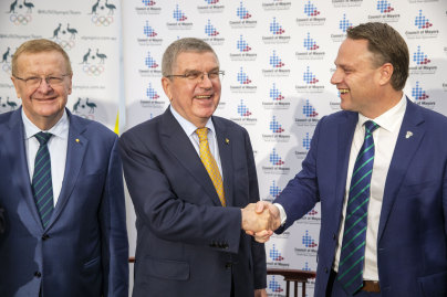 AOC president John Coates, IOC president Thomas Bach and Brisbane Lord Mayor Adrian Schrinner pose for photograph after a meeting with the Council of Mayors South East Queensland in Brisbane.