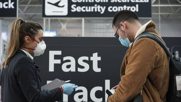 Ground staff give information to passengers at Rome's Leonardo da Vinci international airport.
