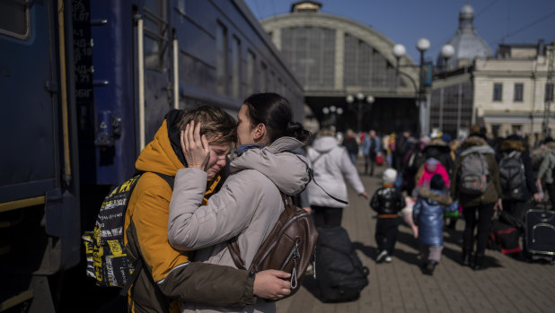 A mother embraces her son who escaped the besieged city of Mariupol and arrived at the train station in Lviv, western Ukraine on Sunday, March 20, 2022. (AP Photo/Bernat Armangue)