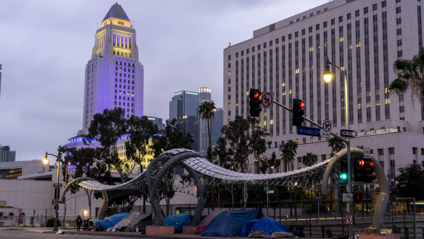 Tents sit on a sidewalk along a road in Los Angeles.