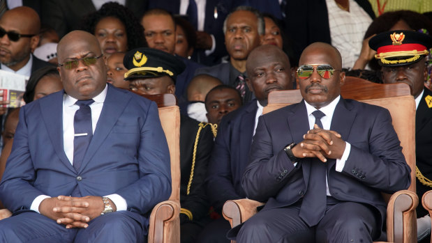 Tshisekedi, left, and outgoing president Joseph Kabila sit side by side during the inauguration ceremony.