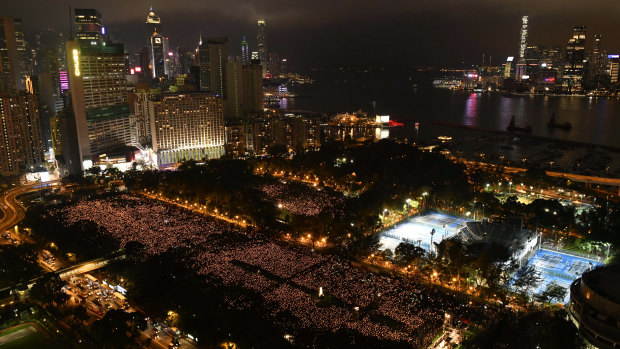 Thousands of people attend a Hong Kong candlelight vigil for victims of the Chinese government's brutal military crackdown in Beijing three decades ago.
