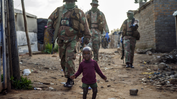 South African National Defence Forces patrol in Johannesburg as residents  protest against the lack of food. Many have lost their income after a strict five-week lockdown in an effort to fight the coronavirus pandemic. 