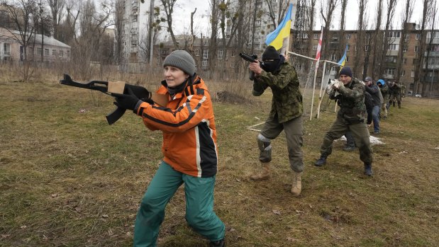 Civilians train with members of the Georgian Legion, a paramilitary unit formed mainly by ethnic Georgian volunteers to fight against Russian forces in Ukraine in 2014, in Kyiv, Ukraine.