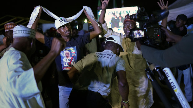 Supporters of incumbent President Buhari's party anticipating a win in Nigeria's election.