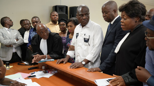 Accompanied by his wife and his lawyers, Congo opposition candidate Martin Fayulu, centre, petitions the constitutional court following his loss in the presidential elections in Kinshasa on Saturday.