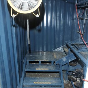 Inside the trap door, police walked down a set of sturdy stairs and into the three shipping containers where the cannabis was grown. 