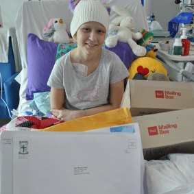 Tess Egginton in Perth Children's Hospital, surrounded by her Warrior Mail delivery.