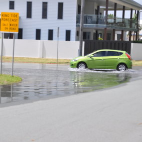 A car negotiates salt water flooding in Second Avenue Scarborough. 